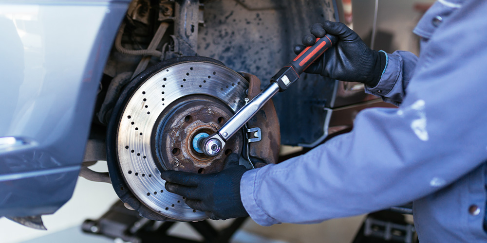 Image Of Mechanic Fixing The Brake